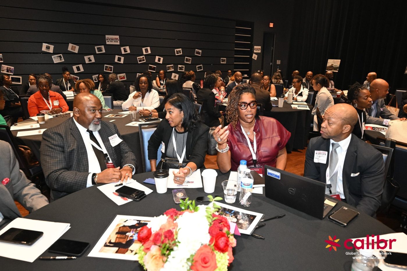 Four people seated at a conference table